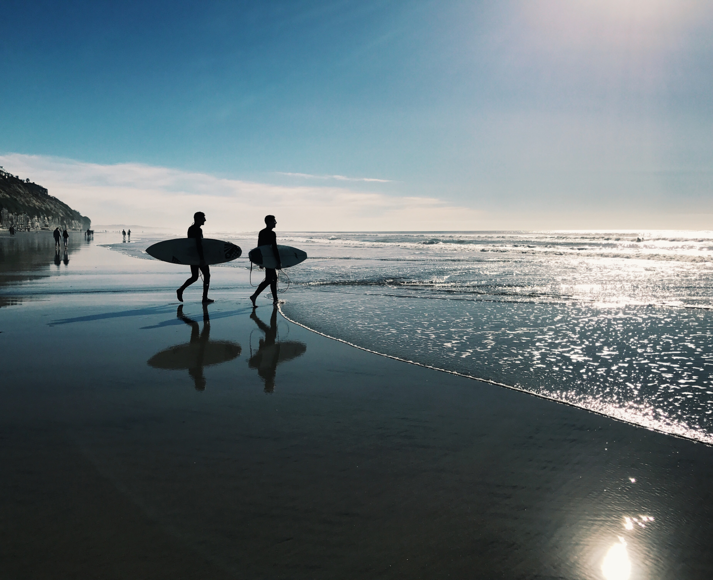 Two surfers walking on the beach